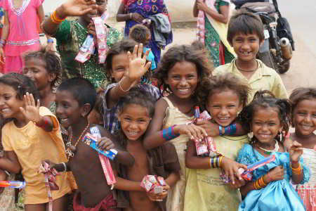 Bunch of Children Smiling with donations in Margao