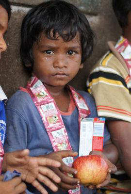 Child with Donations of Health Packs and Apples