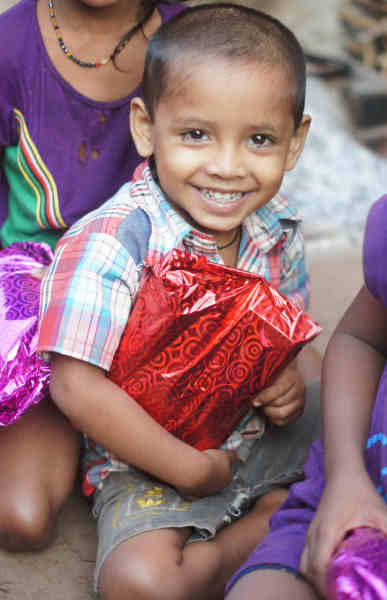 Young child with a large resent and a large smile
