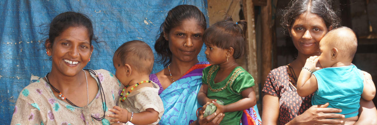Mothers In The Slum With Their Children